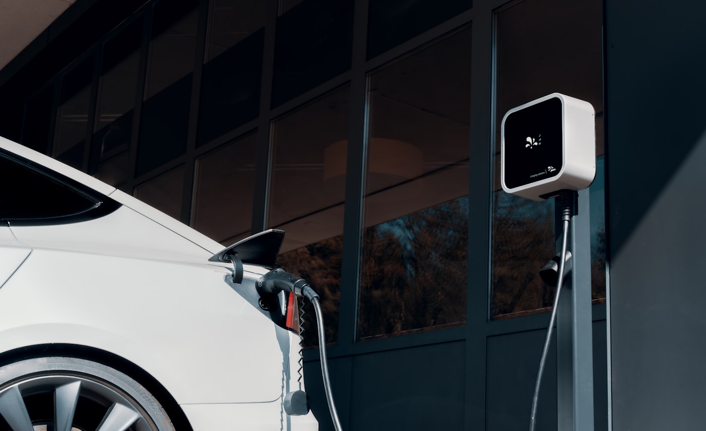 Electric vehicle charging at a building-mounted charger